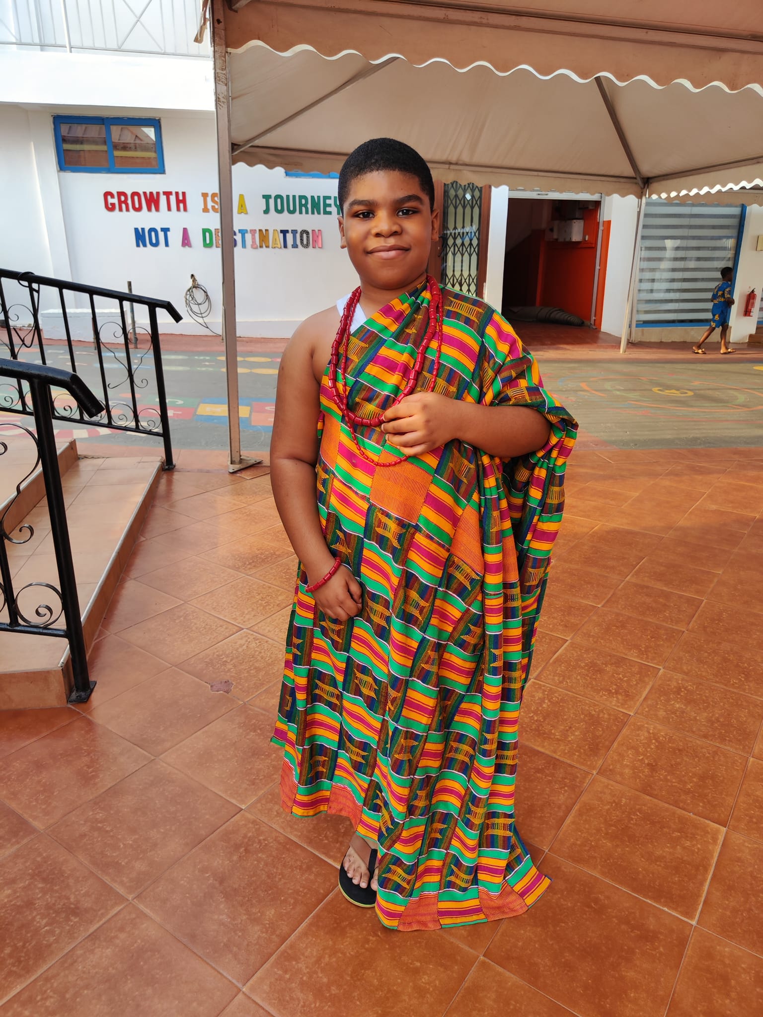 Primary program - student in colorful traditional attire