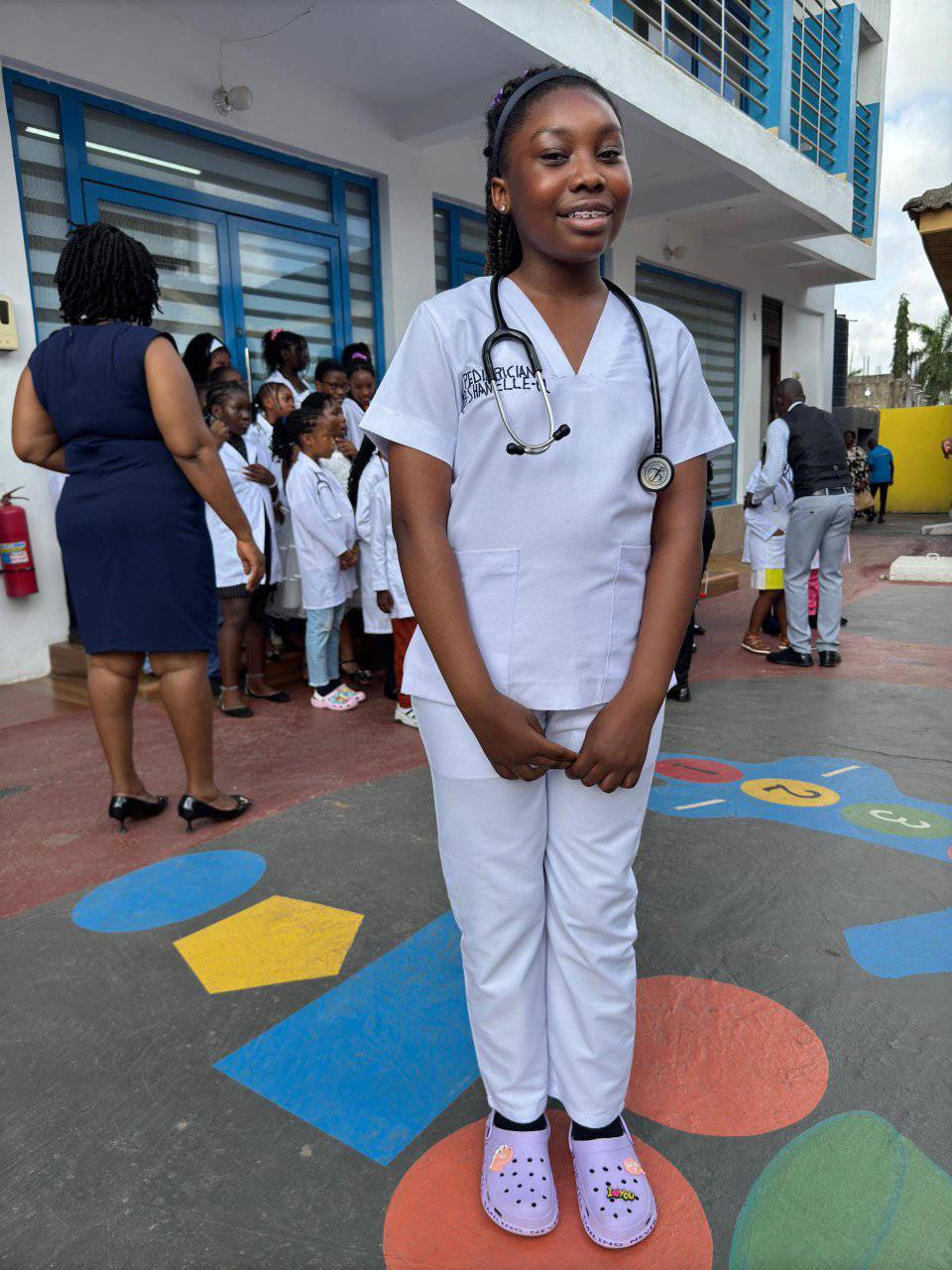 Student in medical scrubs on colorful playground