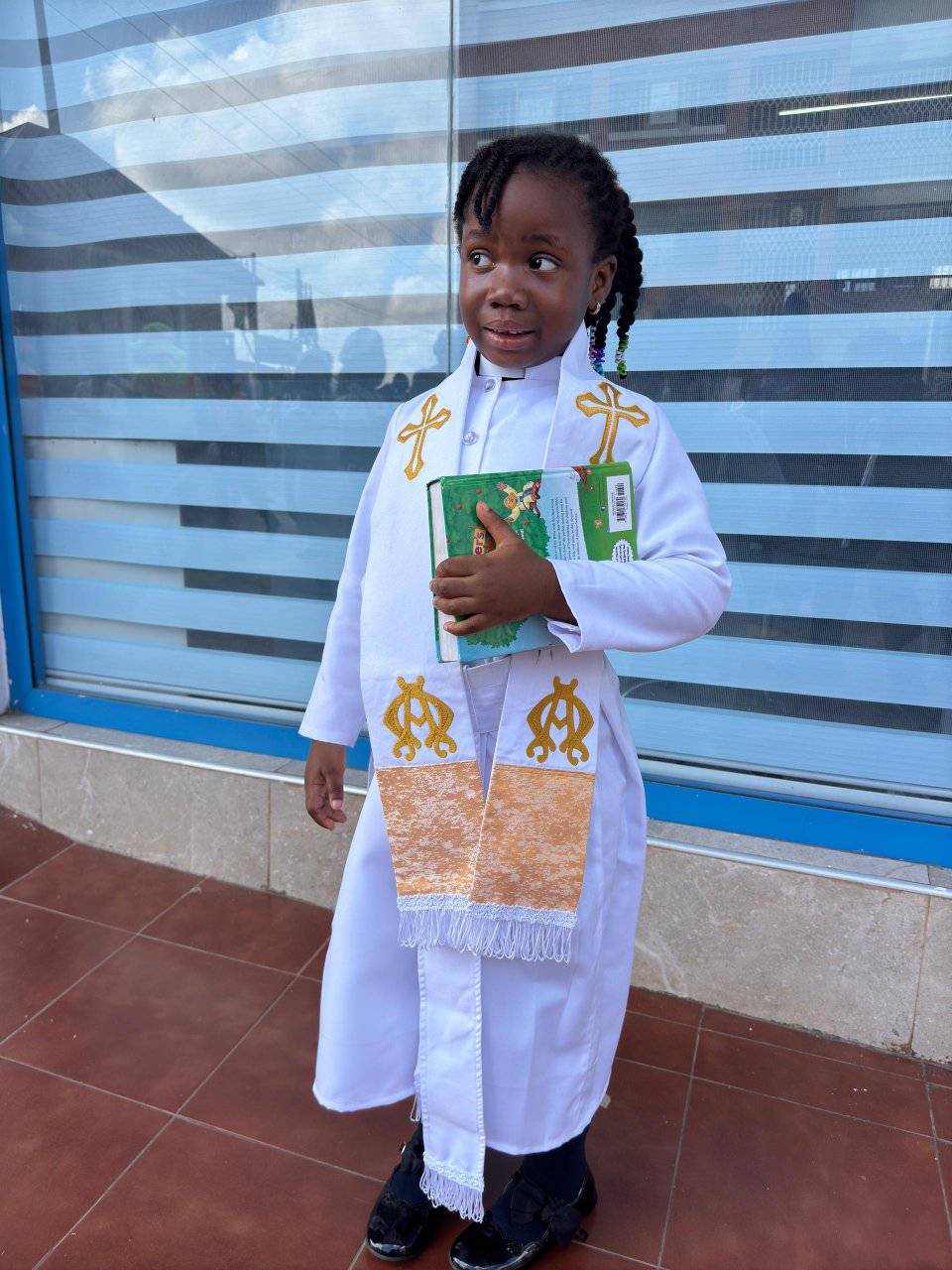 Young student in white religious robes with golden embroidery